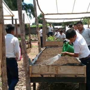 Students watering seedlings at Fray School